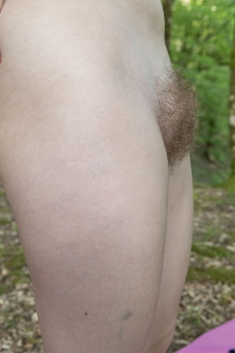 Adby, a hobby doll from the local area, exposes her hairy pussy while practicing yoga in the woods.