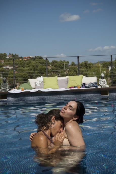 Spanish female sex workers strip before trying to impress their peers by performing oral sex on each other at the pool.