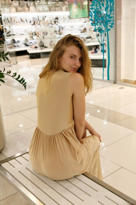 Ukrainian babe Regan Budimir poses in the middle of mall wearing huge sash.