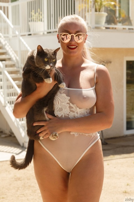 A chubby blonde named Harley Woodburn displays her monster waves with the help of her sheer swimsuits.