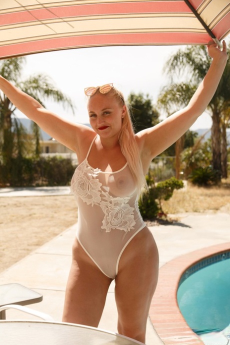 Chubby blonde Harley Woodburn flaunts her oversized body in an alluring swimsuit.