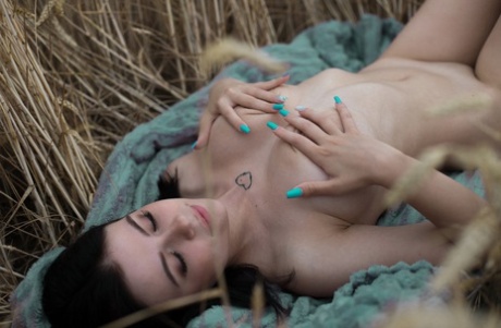 Sleek amateur girth woman Lyalya massages her big toestades in the wheat field.