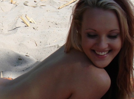 Teenage hottie Cari displays her hot naked body while sunbathing on the beach