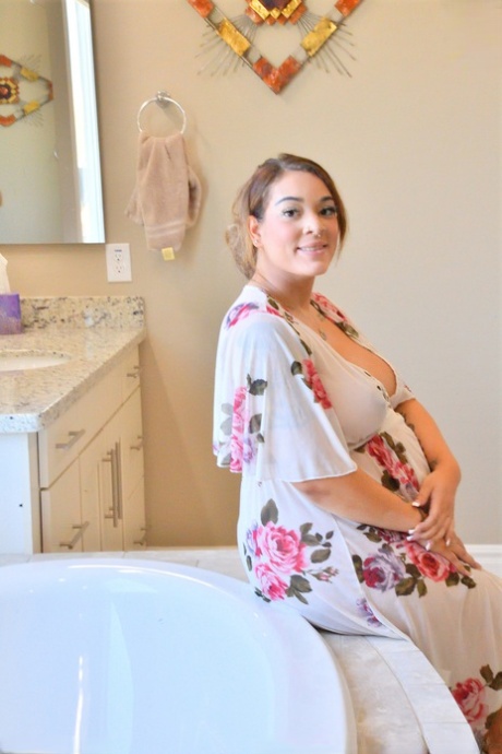 Valerie, who is pregnant with MILF, displays her swollen tits and toys in the bathtub.
