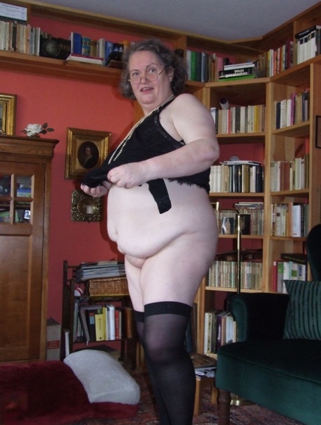 Fat mature woman Birgid strips her clothes & lingerie to show her huge body