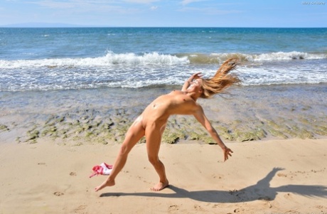 Amateur bikini models Aubrey and Mary nude on the beach, with their bodies affixed to them by their hands.