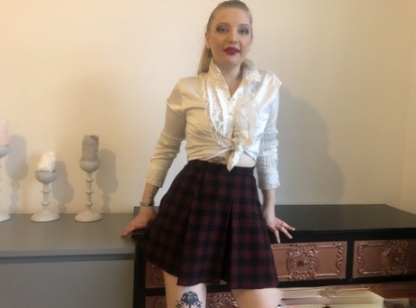 Blonde removes her schoolgirl attire and displays her small tits with large booties.