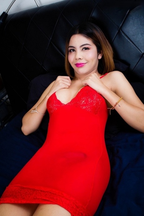 Sexy, Asian shemale Nadia masturbates in a single position while donning her traditional red dress.