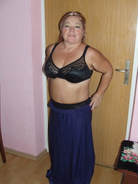 Naughty Granny Regina bares all her fat body parts by stripping off completely.