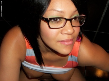 Sweet amateur girl in glasses Krista T unveils her big suckable tits and poses