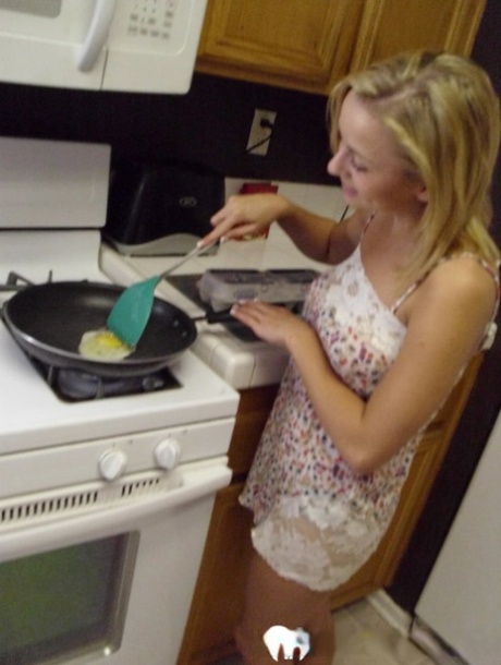 The wife of beauty, Katty West, shows off her large breasts while cooking.