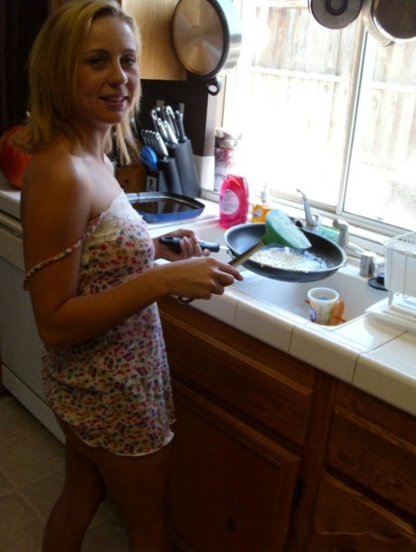 Katty West's wife is charming and unattached, and she displays her prominent breast area during cooking.