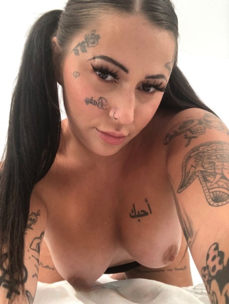 The snob who is not shy to strip down and show off her tattooed body with a few piercings.