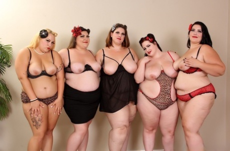 An orgie image shows naughty American BBW models breaking their sleeve while engaging in sexual activity.