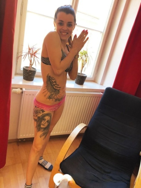 A hairstylist with ponytails exposes her tattooed body and spreads it out with her pussy.