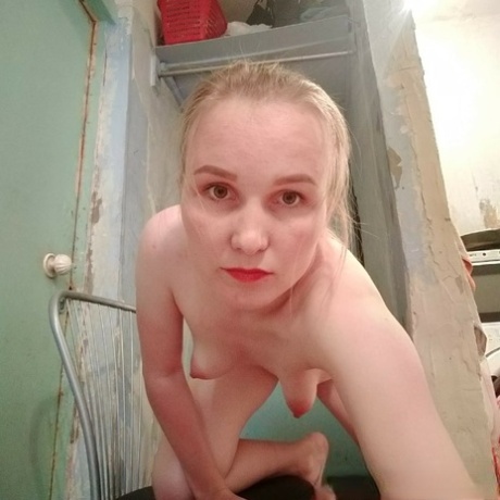 Blonde teen poses naked and teases with her ass and small titties