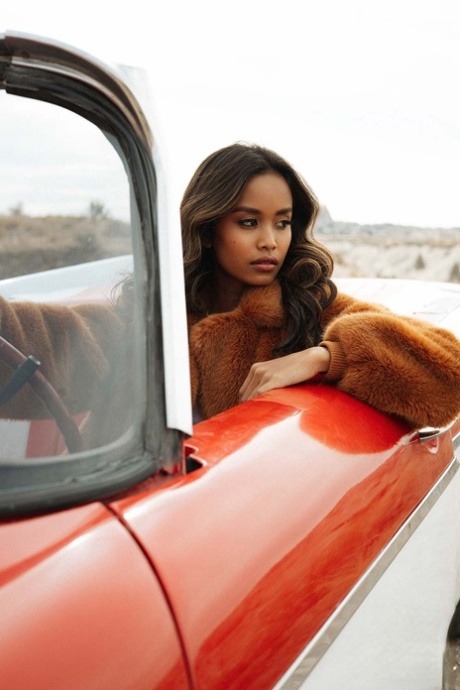 Adorable petite spinner exposes her stunning breast tissue and takes off in a red car outdoors.