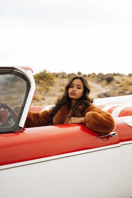 Cute Petite Spinner Reveals Her Amazing Boobs And Poses In A Red Car Outdoors