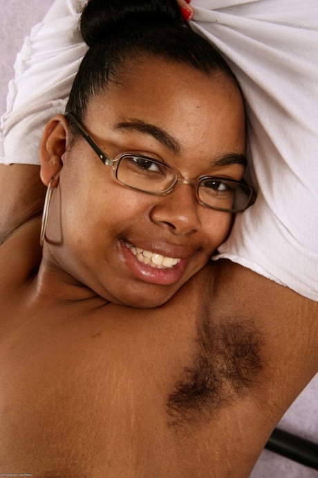 Monica Jimenez, the nerdy and beautiful ebony, displays her bulging figure and unshaved pussy on her chest.