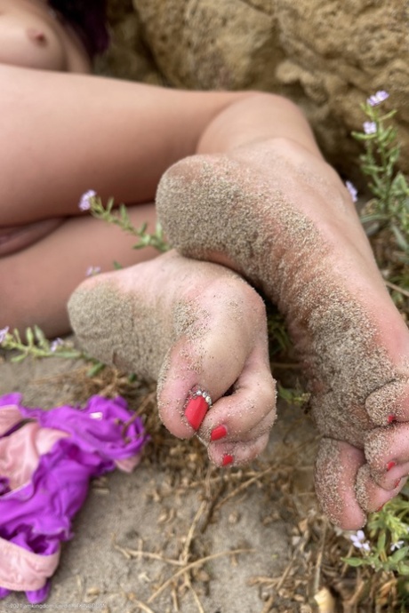 In an outdoor setting, Lily Adams exposes her feet and tampon mouth in closeups.