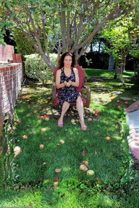 Lustful: GILF Marie stripping and posing next to a tree in the back yard.