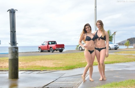 Veronica and Nicole, who are both lesbian amateurs in their early twenties, enjoy a spot of play on the beach while kissing each other.