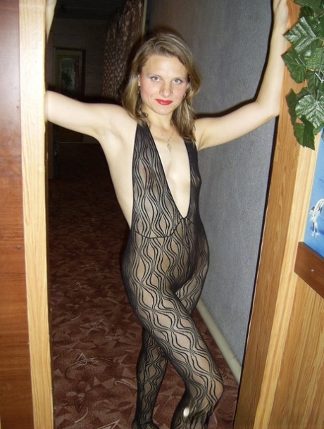 Wearing her red lipstick and bodystocking, the slutty housewife is seen holding up her vacuuming machine.