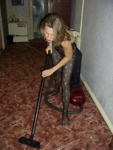 Excessive household worker with red lip makeup posing in her bodystock during a clean-up session.