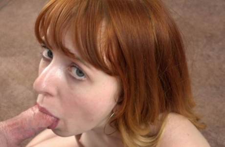 Hannah Grace, the red-headed giraffe, kneels and gives a delightful POV.