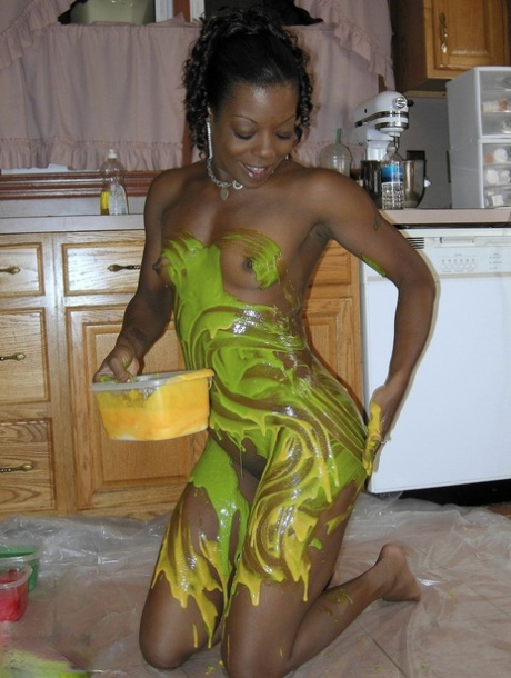 An ebony amateur, Anastasia'S hot body is covered in paint and painted inside her kitchen.