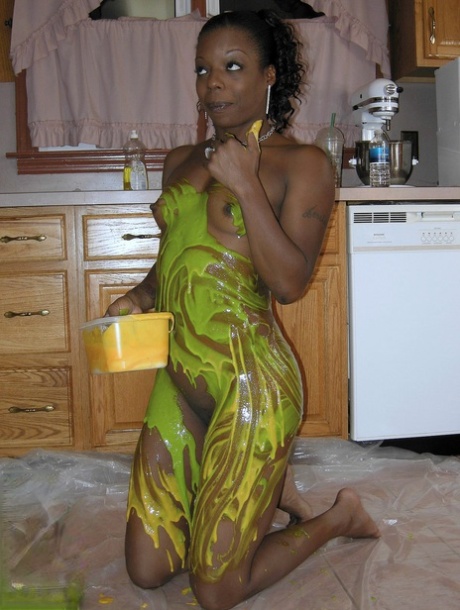Using paint in the kitchen, Ebony amateur Anastasia covers her attractive figure.