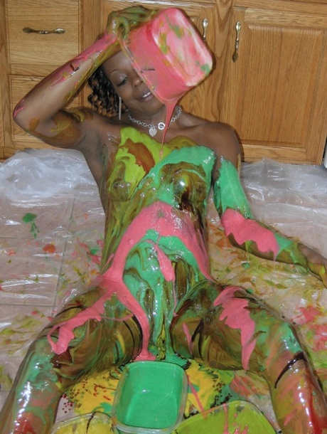 In the kitchen, Anastasia, an ebony amateur, paints herself to hide her radiant figure.