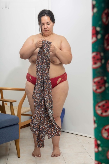 Laury, who is overweight with big boobs, is caught on camera while getting dressed.