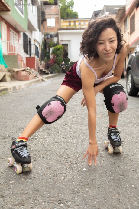 Close up: Roller skater Kira R strips down to the floor and then strobes through her hairy pussy.