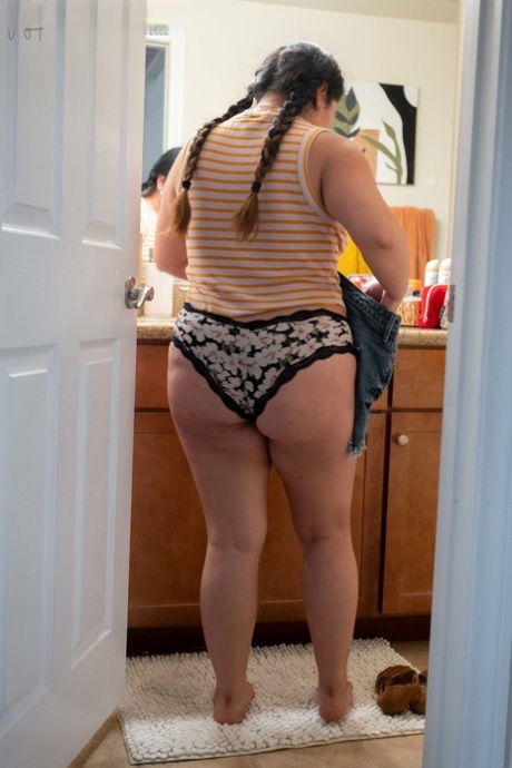 Lola L, the chubby amateur, exhibits her hairy vagina and ample rear end while donning clothes.