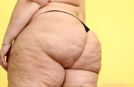 The overweight body of Amateur Erin Green is pictured in high heels, looking nude.