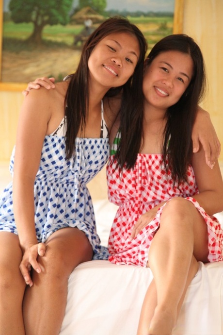 An Asian girl named Anne Agustin and her friend who identifies as lesbians get naked and take pictures on a bed.