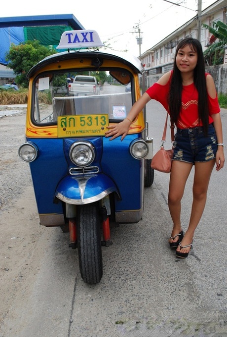 Wearing a booty shorts and showing off her hot legs, Pretty Asian Bew rides in a tuk tuk.