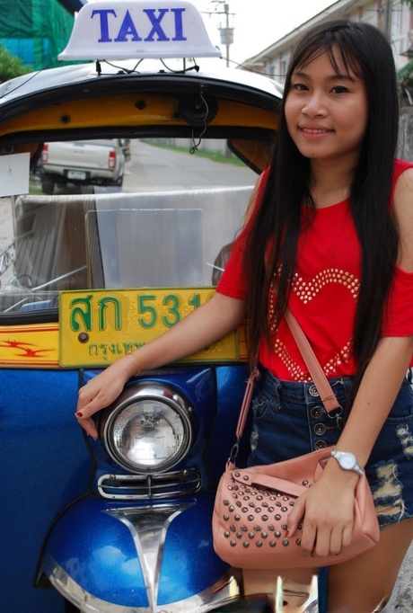 Wearing booty shorts, Bew is showing off her hot legs as she rides in a tuk tuk and looks pretty Asian.