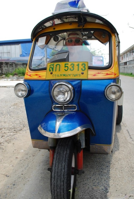 Bew, an Asian lady of pretty appearance, rides in a tuk-tuk and displays her radiant legs in booty shorts.