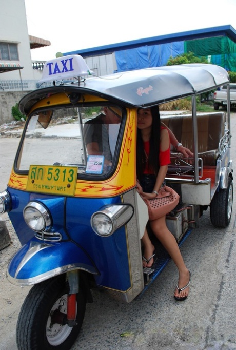 Hot legs: Pretty Asian Bew waves in a ‘tuk-tab’ while flaunting her booty shorts on the back of a tuk tuk.