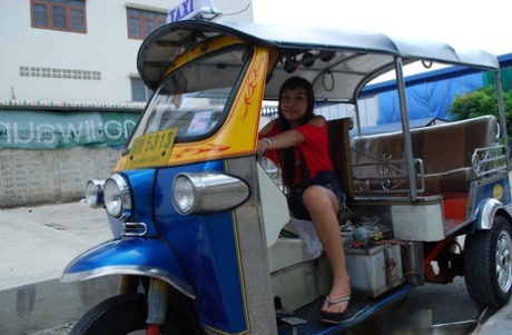 Pretty Asian Bew poses in a tuk-toobility while flaunting her glowing abs beneath booty shorts.