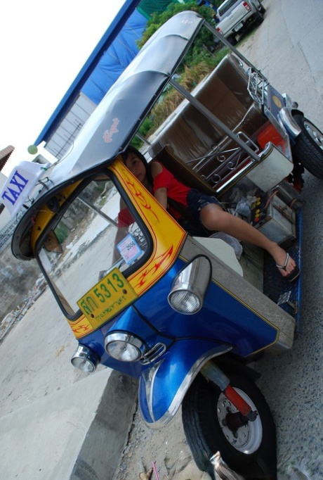 In a tour-style vehicle, Bew, an Asian of appearance, displays her radiant legs in booty shorts.