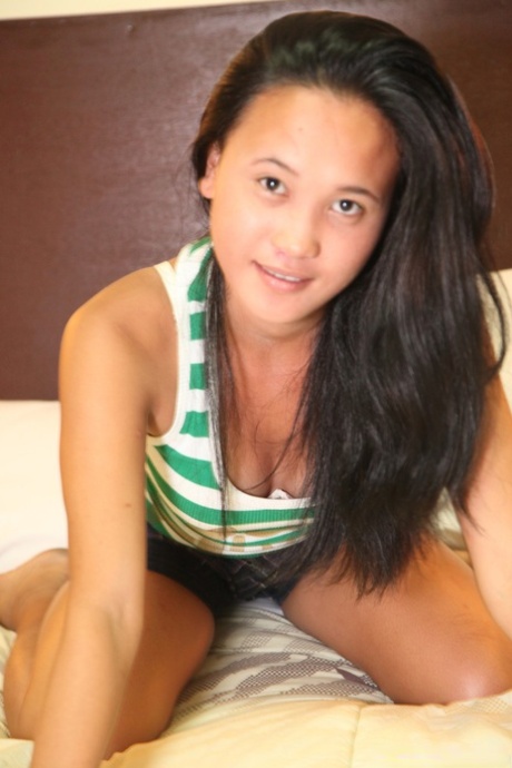 The cute Filipina model Ladylyne Salazar strippers and posing before having sexual intercourse.