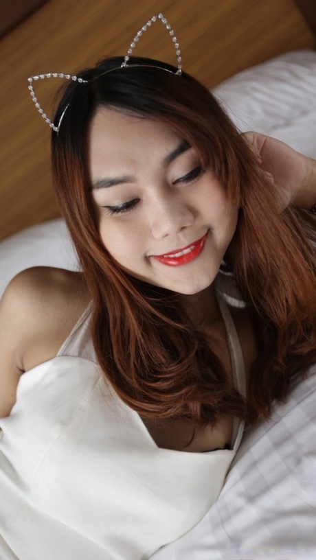 In this video, an Asian woman with red lipstick gives a daring fist and enjoy the anal sex.