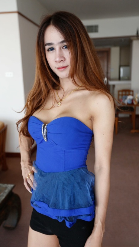 Donning her sexy outfit, the seductive ladyboy fronts up to reveal her sizable breasts.