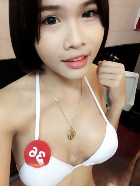 Gogo, an Asian woman of beauty who is pictured naked and in hot clothing, taking daring selfies.