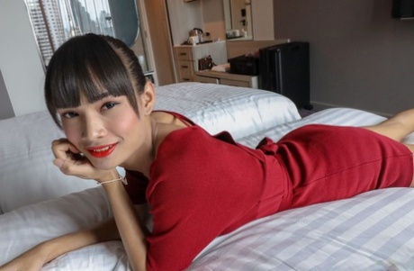 Mei, the brunette Asian female, undress and removes her red dress.