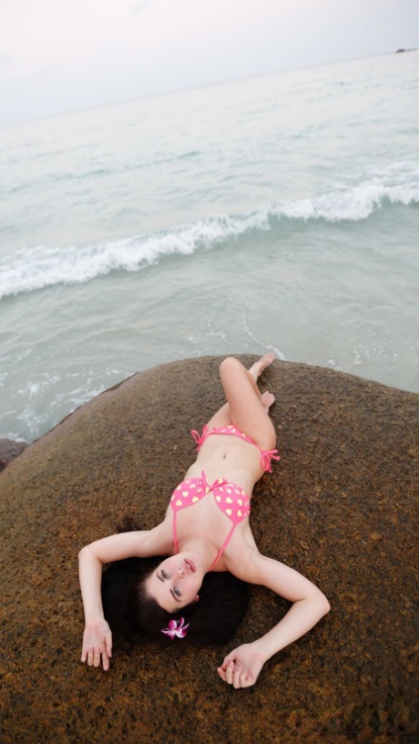 In a cute bikini, Cassie's girlfriend from Europe takes her picture before tasting some edible fish.