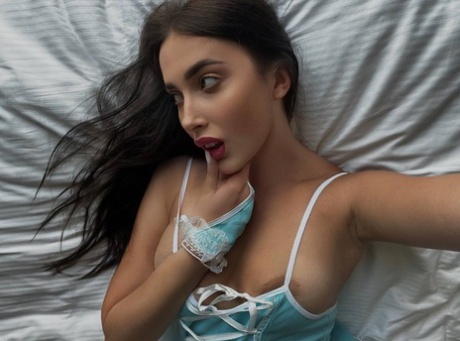 The hot nightgown and stockings of Katiiia, the only female model from OnlyFans, are featured in a photo featuring her.